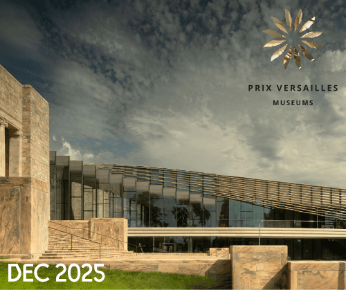Modern museum building with large glass windows and stone accents under a dramatic sky. "PRIX VERSAILLES MUSEUMS" and a gold emblem appear in the upper right. "DEC 2025" is written in white in the bottom left corner.
