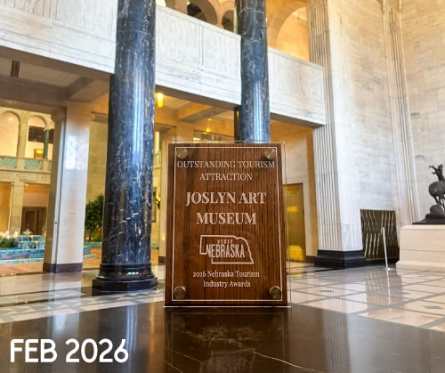 A plaque honoring Joslyn Art Museum as an outstanding tourism attraction sits in a grand marble lobby. The plaque mentions the 2026 Nebraska Tourism Industry Awards. "FEB 2026" is written in white at the bottom left.