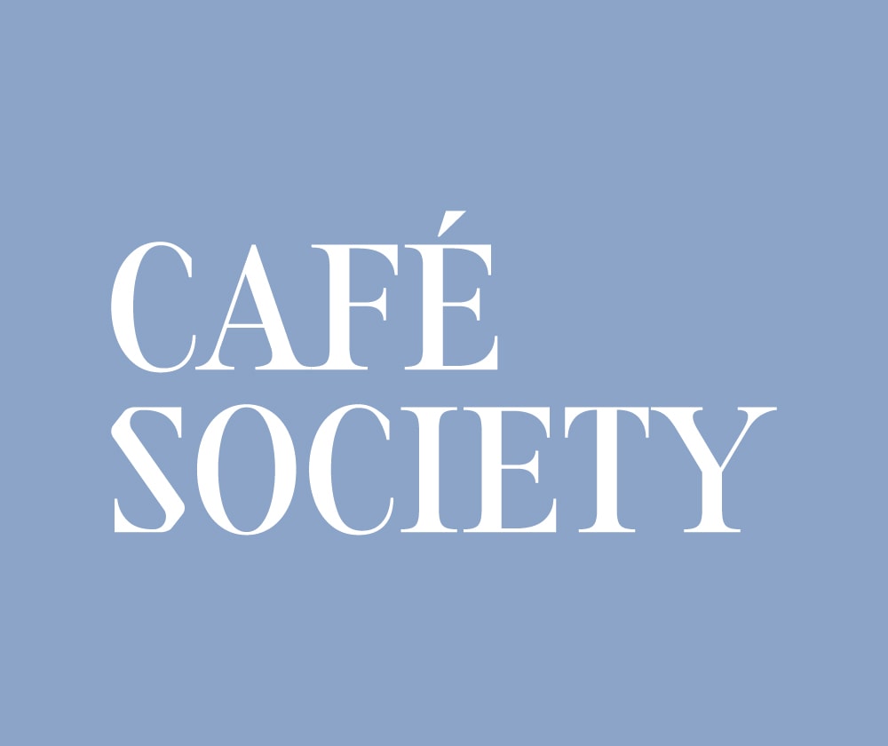 White text reads “CAFÉ SOCIETY” in all caps with a serif font, centered on a solid light blue background.